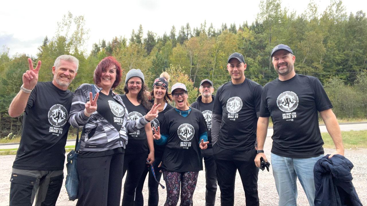 Tetra Tech employees in Healthy Life Challenge shirts smile for a photo while on a hike in Quebec